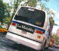 rear view of MTA bus displaying Les Misérables advertising poster